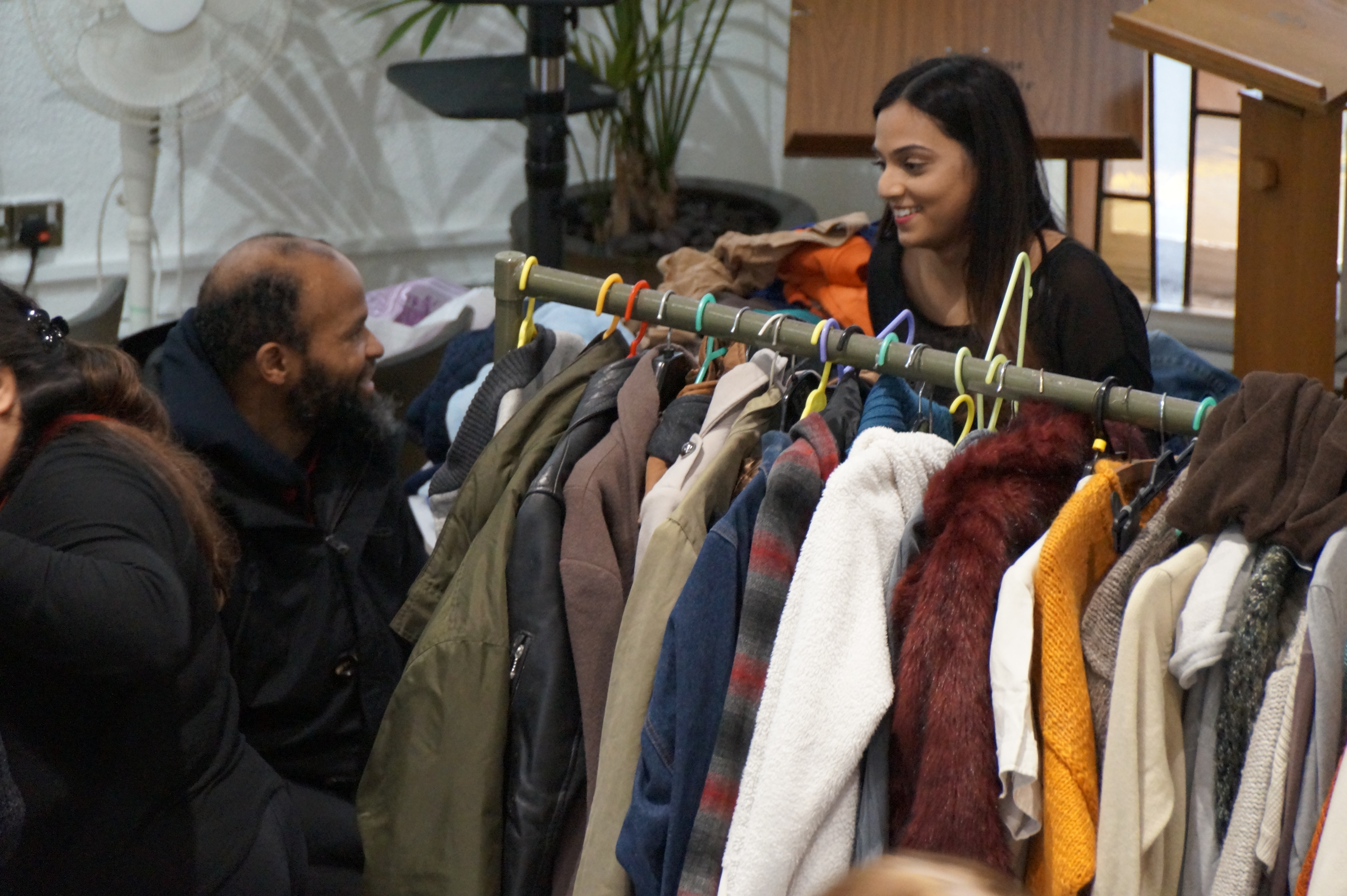 A volunteer giving out clothes to a homeless man at Carrs Lane Church (Photograph: Birmingham Food Drive)